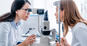 adult female doctor ophthalmologist checking eye